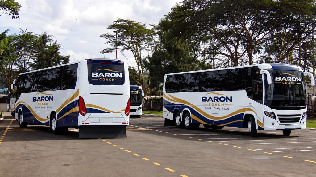 Baron Coach buses parked in the yard.